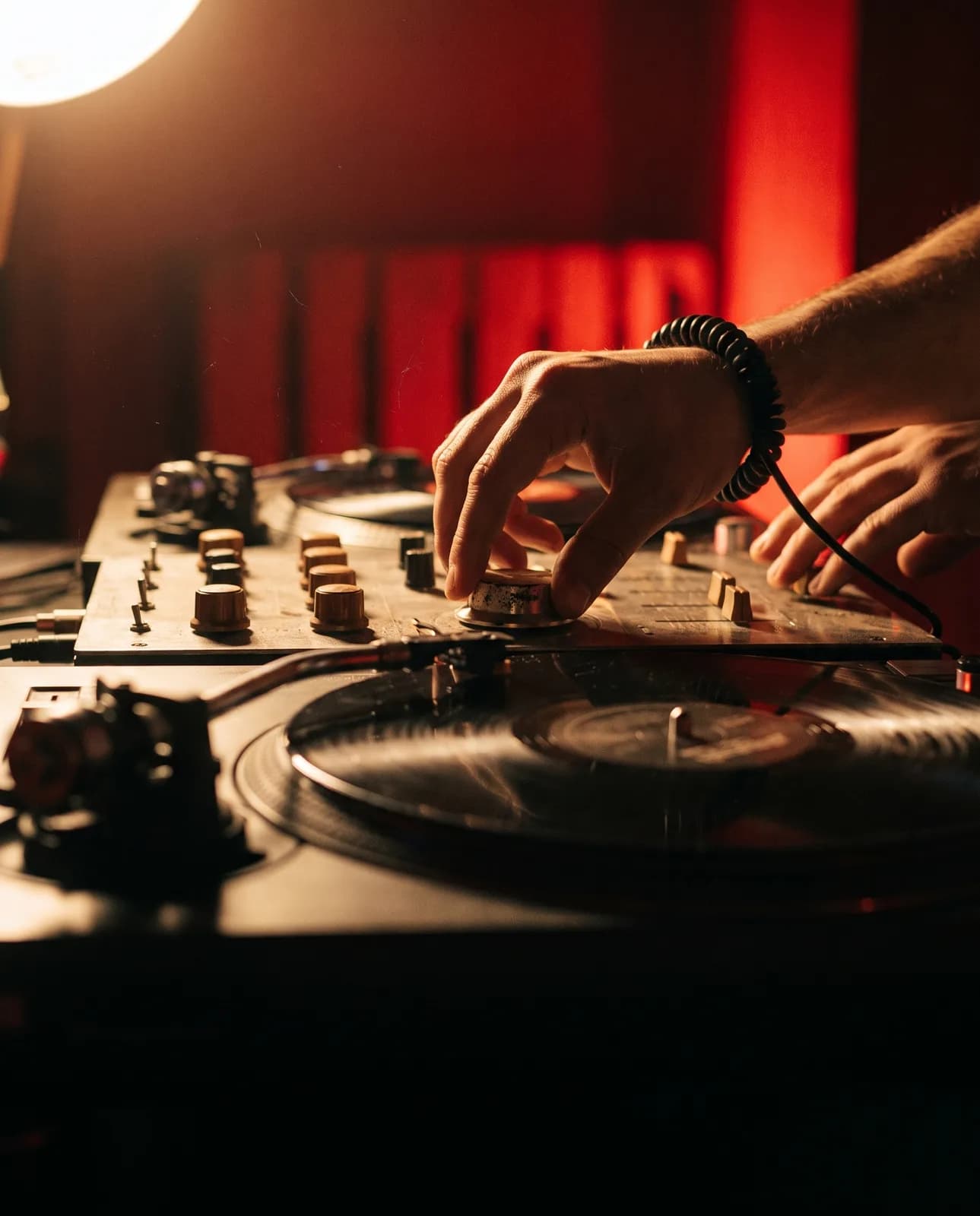 Campaign image: hands on a rotary mixer, a record spinning in the foreground
